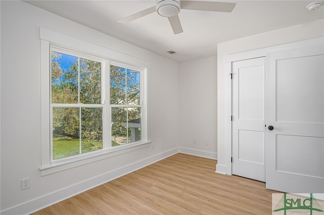 unfurnished bedroom with a closet, ceiling fan, and light wood-type flooring