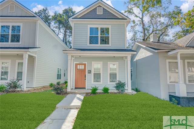 view of front of home with a porch and a front lawn