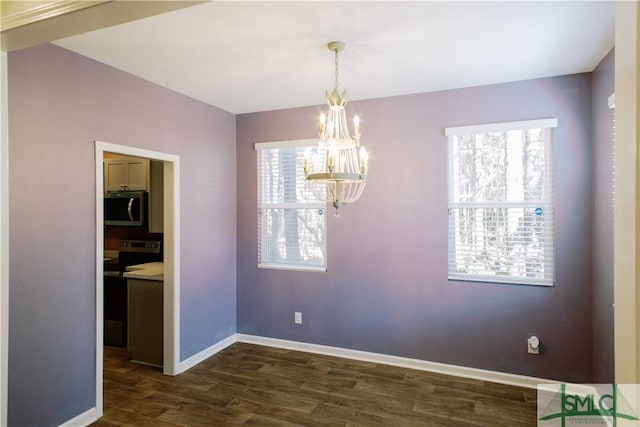 unfurnished dining area with dark hardwood / wood-style floors and a notable chandelier