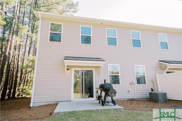 rear view of house featuring cooling unit and a patio