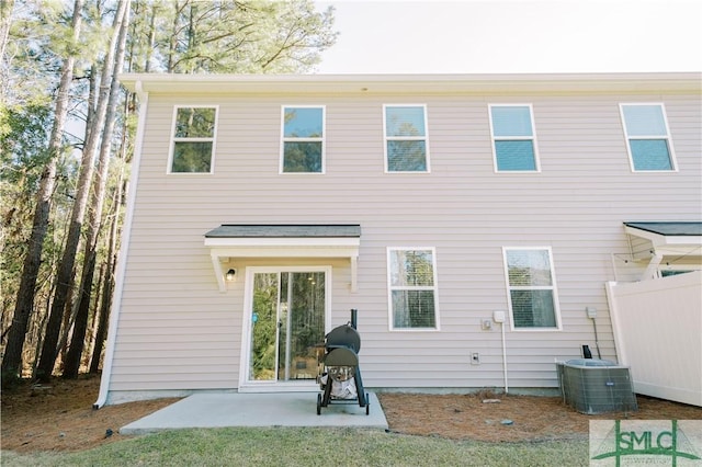 back of house with cooling unit and a patio