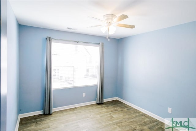 spare room featuring ceiling fan and light hardwood / wood-style floors