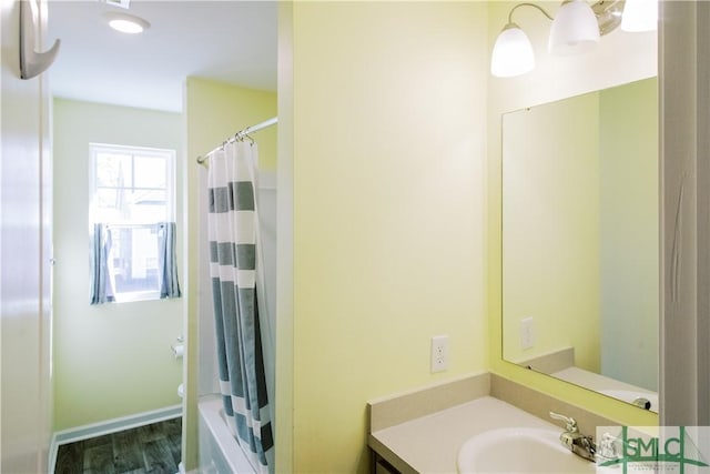 full bathroom with toilet, vanity, shower / bathtub combination with curtain, and hardwood / wood-style flooring