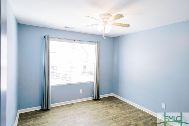 unfurnished room with ceiling fan, light wood-type flooring, and a wealth of natural light