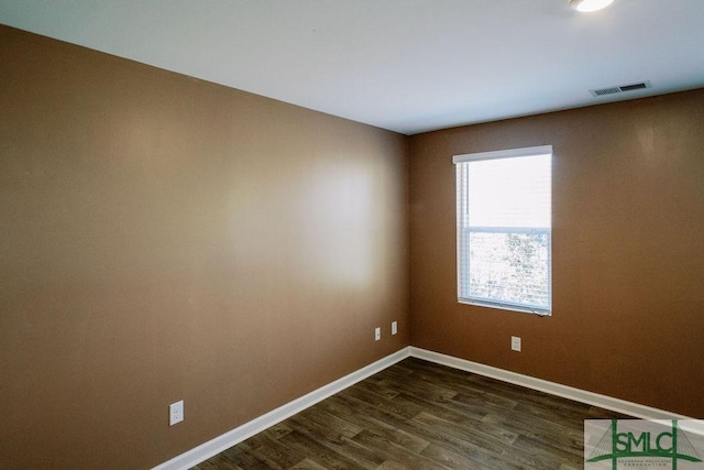 spare room featuring dark hardwood / wood-style floors