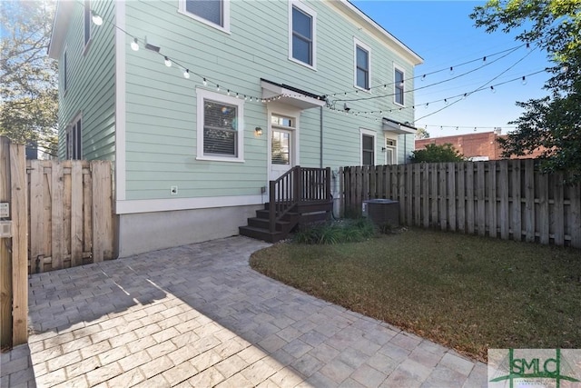 rear view of property with a patio area and a yard