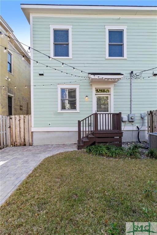 rear view of property featuring a yard