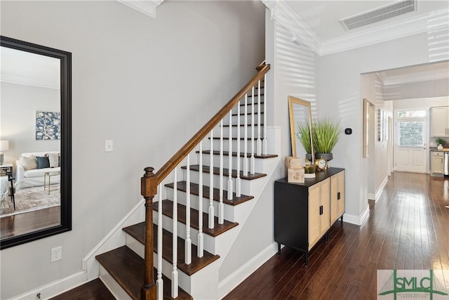 stairs featuring wood-type flooring and crown molding