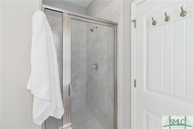 bathroom featuring a shower with shower door