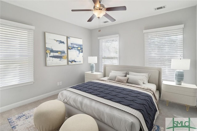 bedroom with ceiling fan and light colored carpet