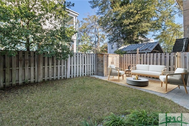 view of yard with outdoor lounge area, a storage shed, and a patio