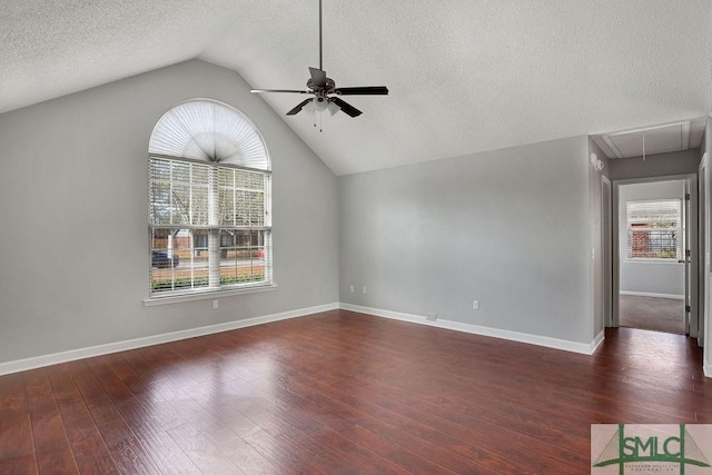 unfurnished living room with ceiling fan, a textured ceiling, dark hardwood / wood-style floors, and lofted ceiling