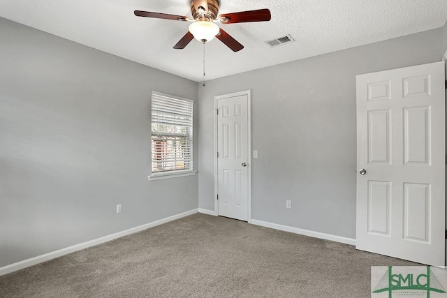 unfurnished bedroom featuring ceiling fan and carpet floors