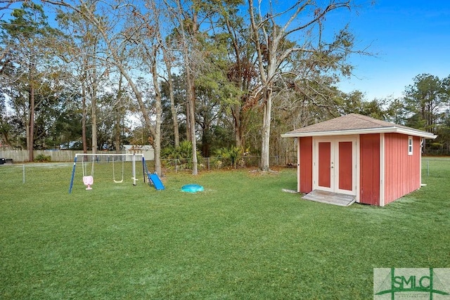 view of yard featuring a playground and a shed