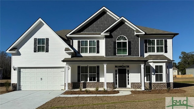 craftsman inspired home with a garage and a porch