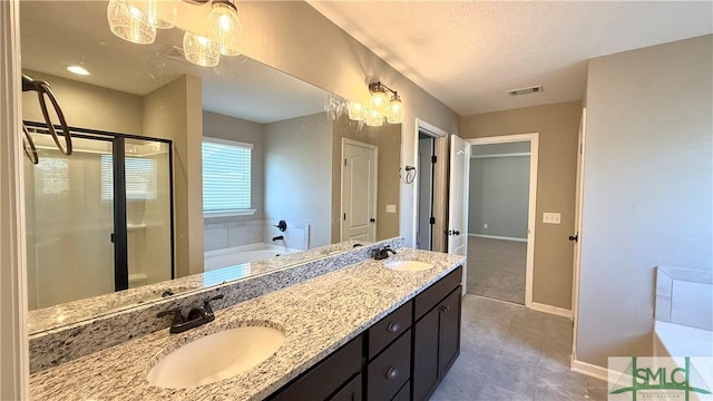 bathroom featuring vanity, an inviting chandelier, and shower with separate bathtub