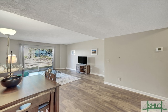 living room featuring a textured ceiling and hardwood / wood-style flooring