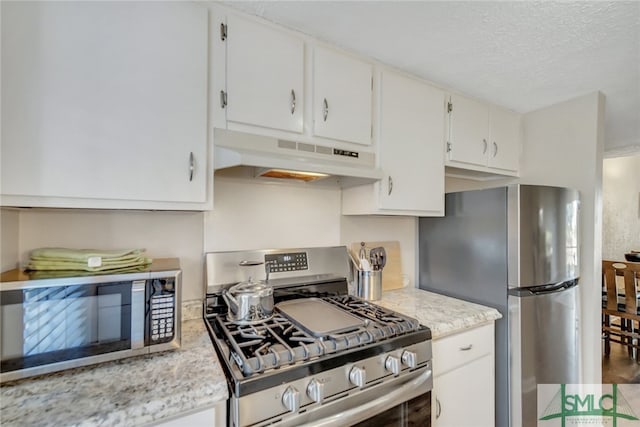 kitchen featuring white cabinets, appliances with stainless steel finishes, and a textured ceiling