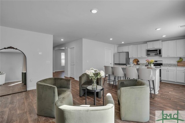 living room with dark hardwood / wood-style flooring