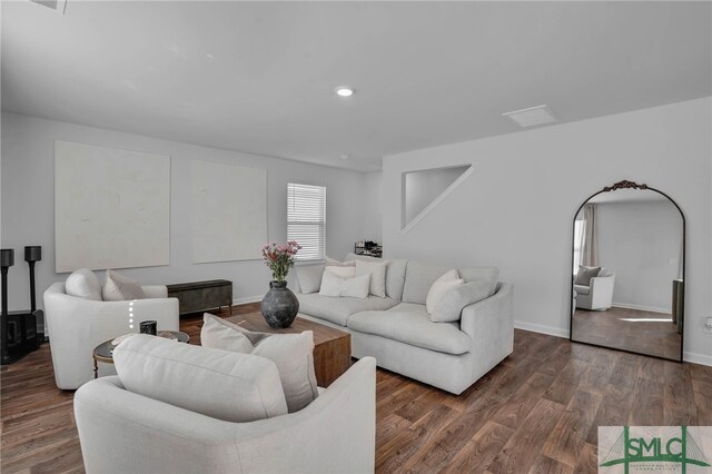 living room with dark hardwood / wood-style flooring