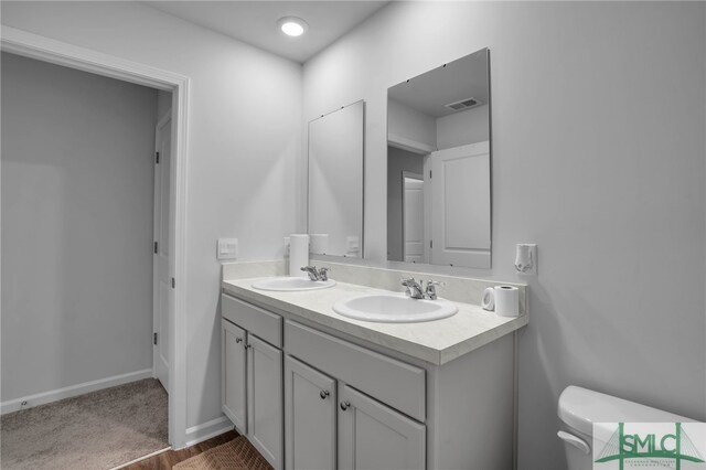 bathroom featuring toilet and vanity