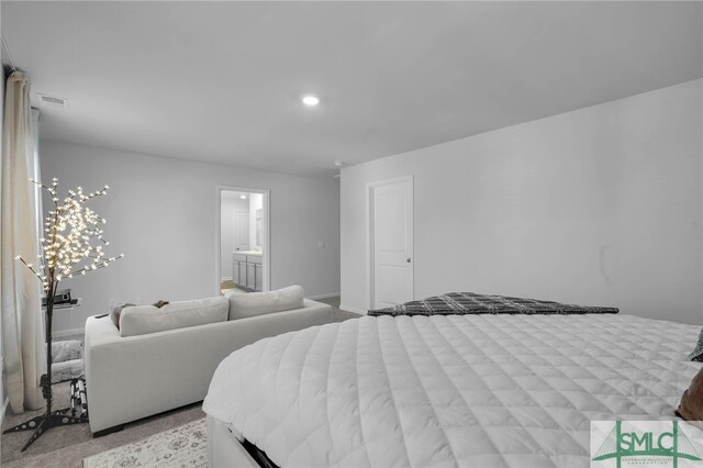 carpeted bedroom featuring connected bathroom