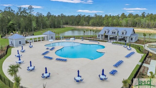 view of swimming pool with a patio area, a water view, and a pergola