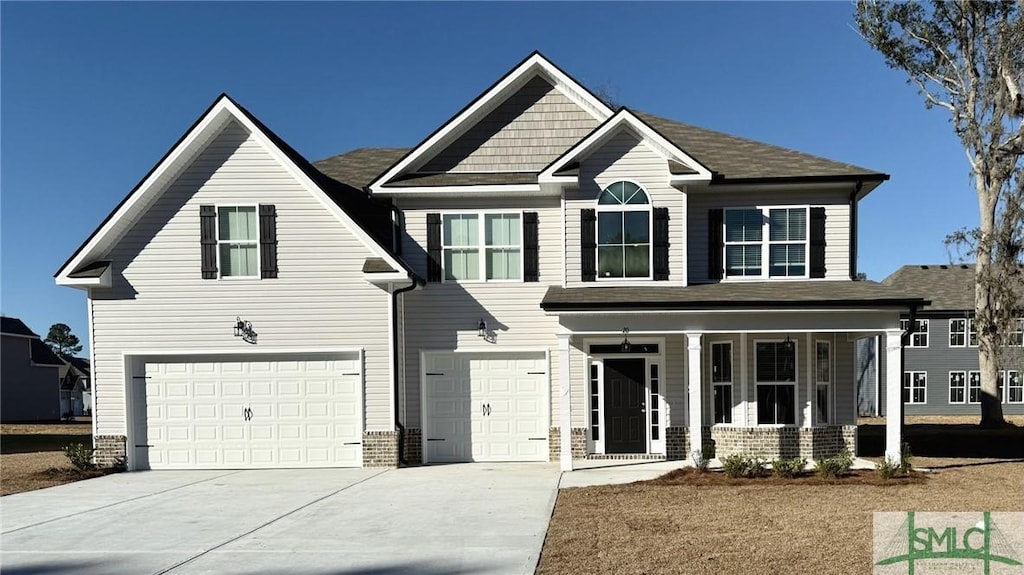 view of front of house with covered porch and a garage