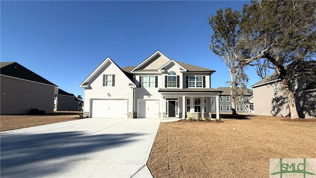 view of front facade with a front yard, a porch, and a garage