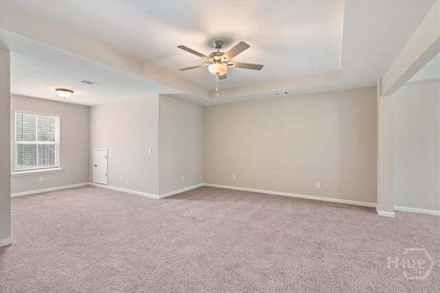 20 Cottonfield Dr, Guyton, GA 31312 - carpeted empty room with a ceiling fan, a tray ceiling, and baseboards