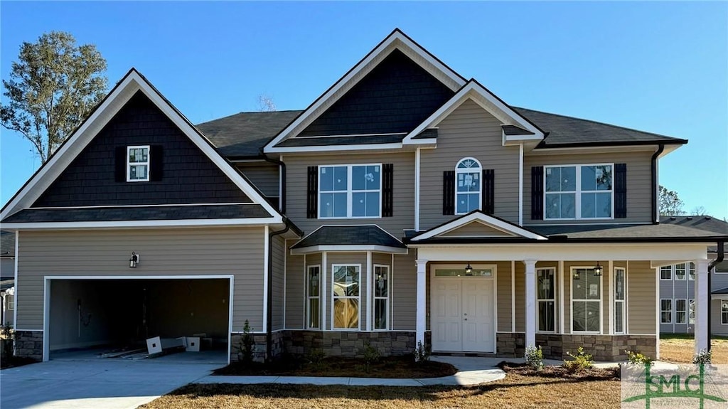 craftsman-style house featuring covered porch and a garage