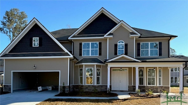 craftsman house with a garage and a porch