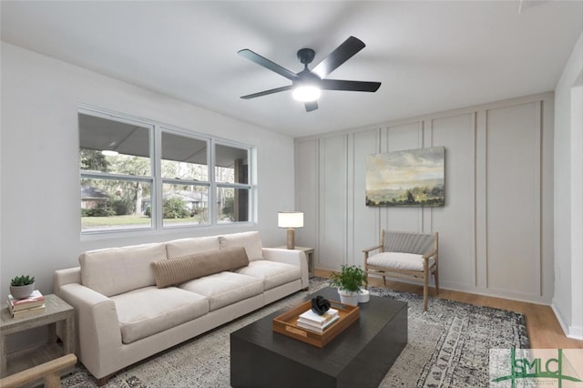 living room featuring ceiling fan and light hardwood / wood-style flooring