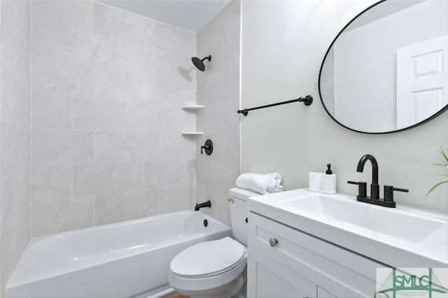 full bathroom featuring toilet, vanity, and tiled shower / bath