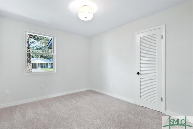 empty room featuring light carpet