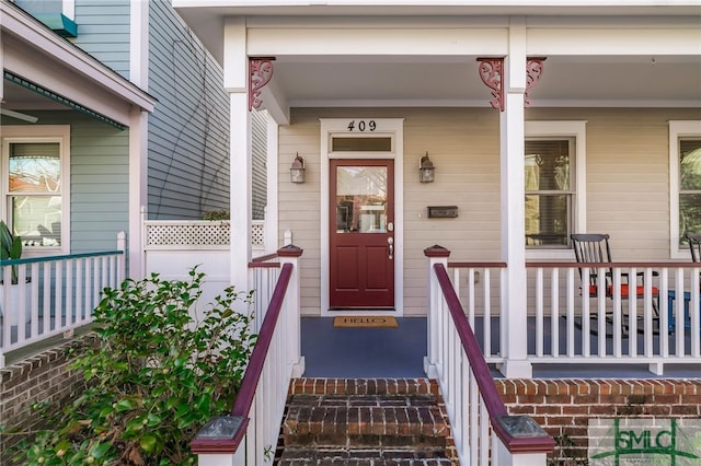 view of exterior entry with a porch