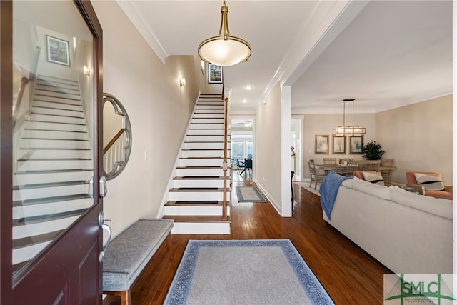 stairs featuring ornamental molding and hardwood / wood-style floors