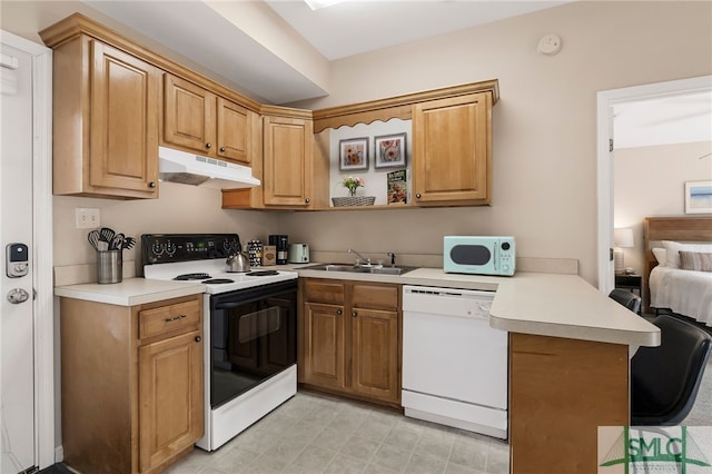 kitchen with sink, kitchen peninsula, and white appliances