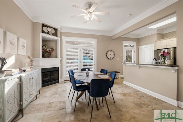 dining area featuring ceiling fan and crown molding