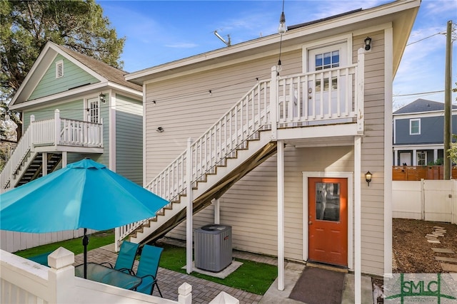 rear view of property featuring central AC unit and a patio