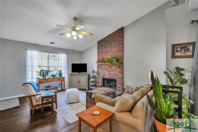 living room with ceiling fan, vaulted ceiling, a fireplace, and dark hardwood / wood-style floors