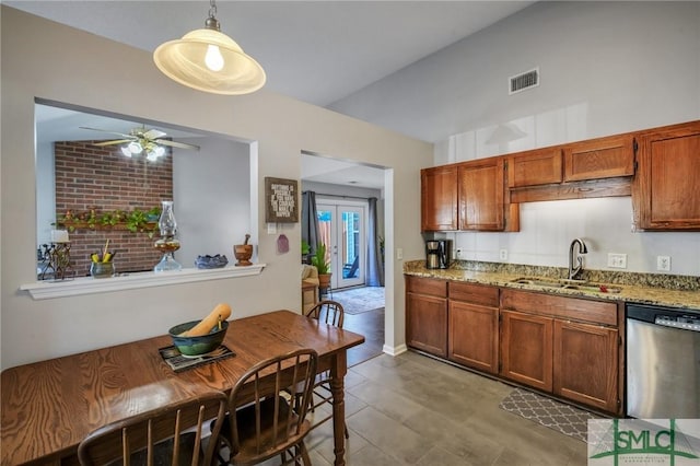 kitchen featuring light stone countertops, dishwasher, sink, hanging light fixtures, and ceiling fan