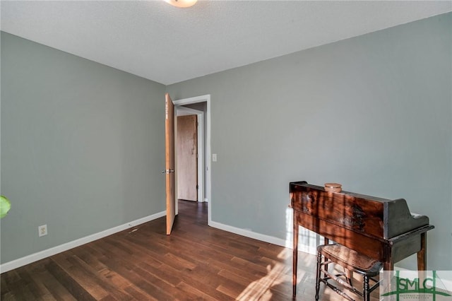 home office with dark hardwood / wood-style floors