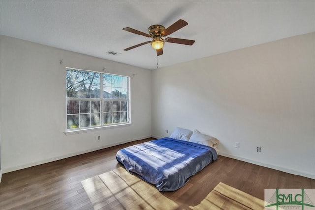 bedroom featuring ceiling fan and dark hardwood / wood-style floors