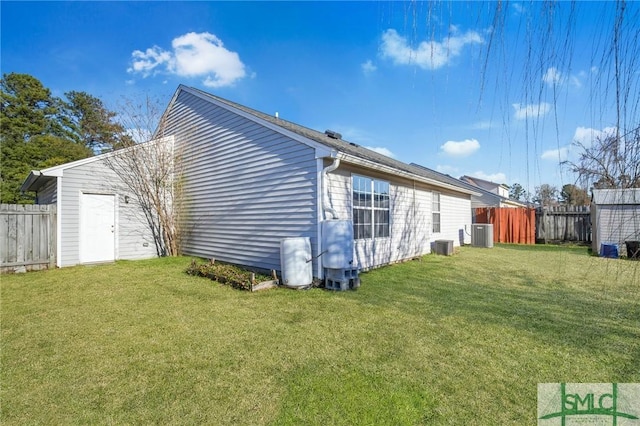 view of property exterior with a lawn and central air condition unit