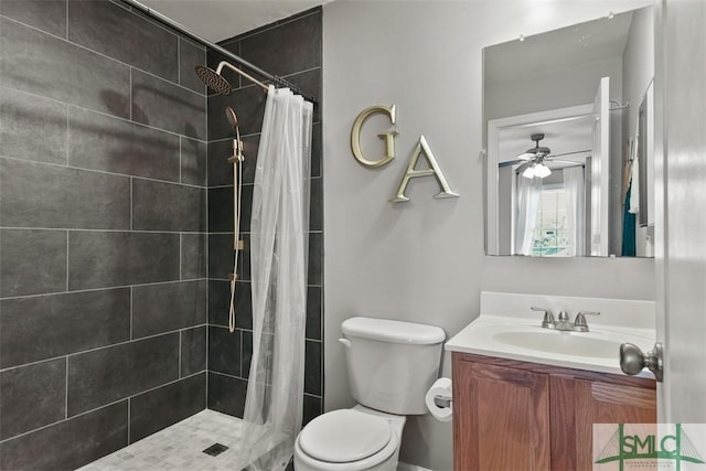 bathroom with toilet, vanity, ceiling fan, and a shower with shower curtain