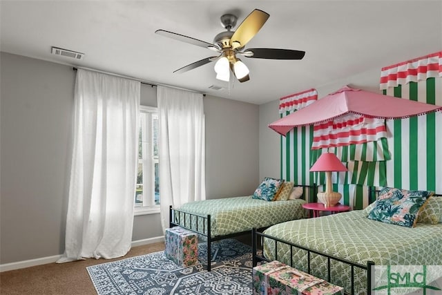 bedroom featuring ceiling fan, carpet, and multiple windows