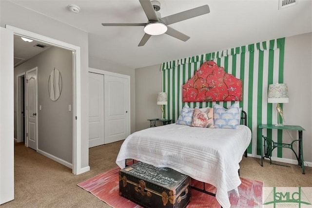 carpeted bedroom with ceiling fan and a closet