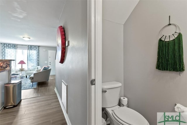 bathroom with toilet and hardwood / wood-style floors