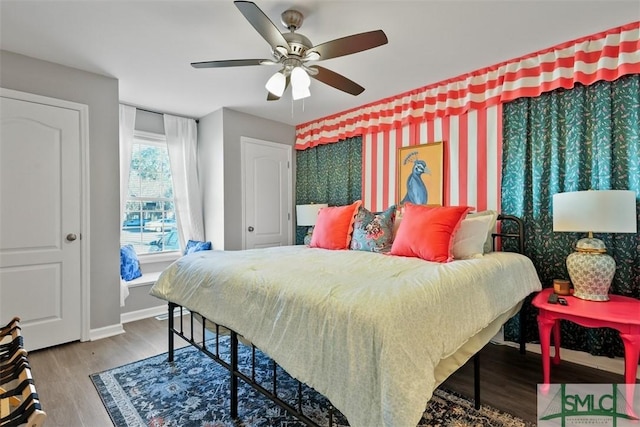 bedroom with ceiling fan and hardwood / wood-style flooring